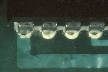 Figure 6: The legend on this PCB has contaminated the top of the plated through holes Figure 6: The legend on this PCB has contaminated the top of the plated through holes